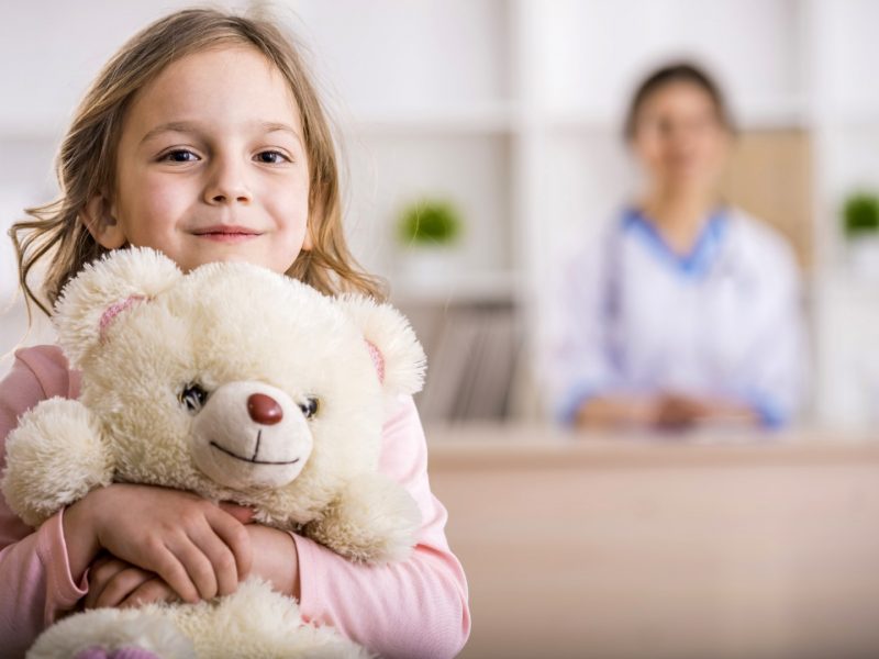 Little,Girl,With,Teddy,Bear,Is,Looking,At,The,Camera.